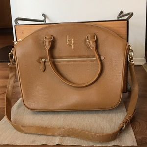 a brown purse and a shoulder strap is included